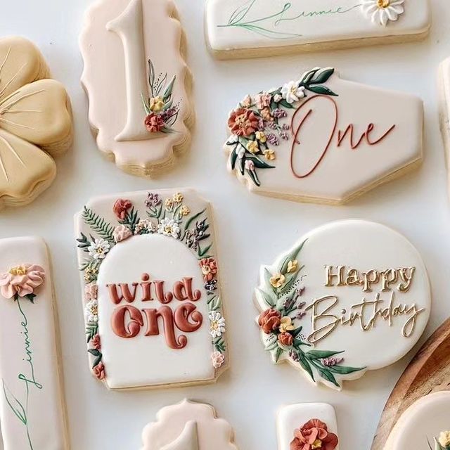 decorated cookies with the words wild one and happy birthday written on them are laid out