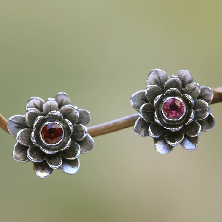 Symbols of holiness and divinity two lotus flowers unfold their petals with glistening elegance. They reveal a glowing heart of garnet. The earrings' design is by Nyoman Rena who crafts them of sterling silver and gives the earrings an antique finish. Rose Applique, Paw Print Jewelry, Ribbon Jewelry, Printed Jewelry, Button Earrings, Garnet Earrings, Silver Work, Jewelry Packaging, Jewelry Gift Box