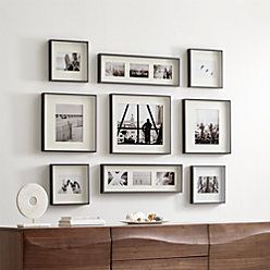 a living room with pictures on the wall and an entertainment center in front of it