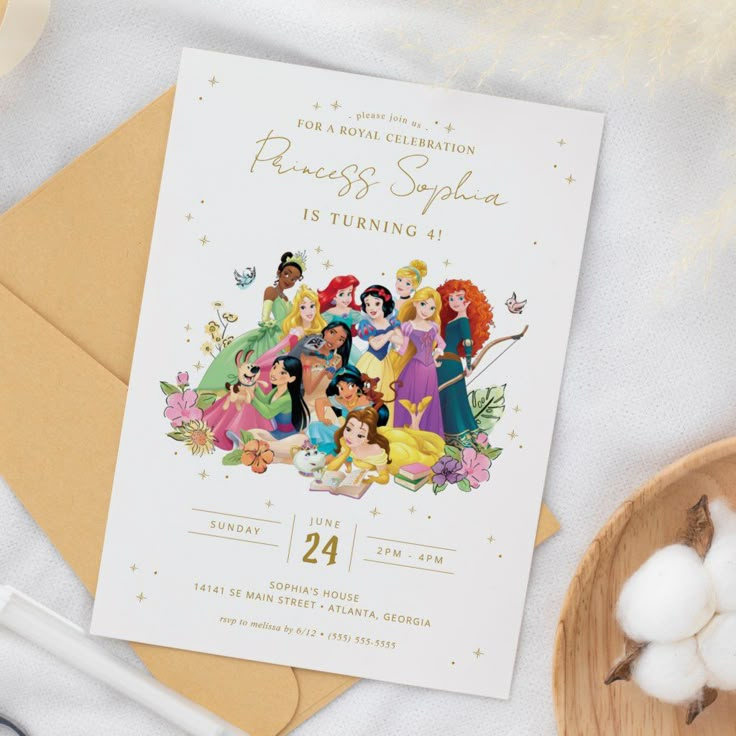 a birthday card with princesses on it sitting next to some marshmallows