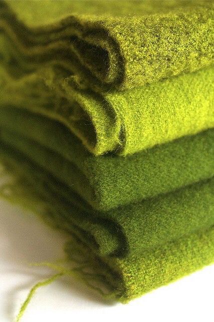 four green towels are stacked on top of each other