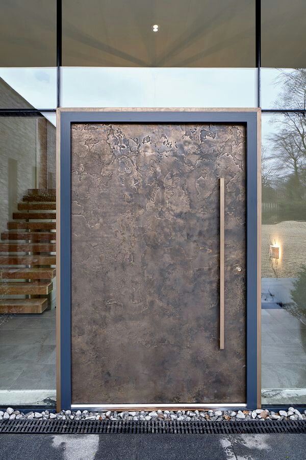 an entrance to a building with glass doors and stone steps leading up to the front door