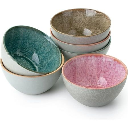 four bowls are stacked on top of each other, one is pink and the other is green