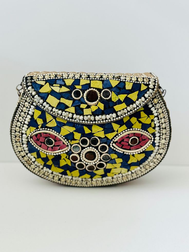 This statement mosaic clutch is a true work of art, handcrafted with meticulous attention to detail. It showcases a mesmerizing design composed of vibrant, colorful mosaic patterns that catch the eye and add a touch of elegance to any outfit. At Indus Threads, we believe that accessories should not only be functional but also make a bold fashion statement. This evening purse is designed to be a versatile accessory, perfect for both casual and special occasions and easily fits your phone and othe Bohemian Multicolor Clutch For Evening, Artisan Multicolor Clutch As A Gift, Traditional Multicolor Clutch For Evening, Traditional Handmade Multicolor Evening Bag, Bohemian Multicolor Evening Clutch, Traditional Multicolor Handmade Clutch, Artisan Multicolor Rectangular Clutch, Bohemian Gold Beaded Clutch, Bohemian Clutch With Multicolor Embroidery