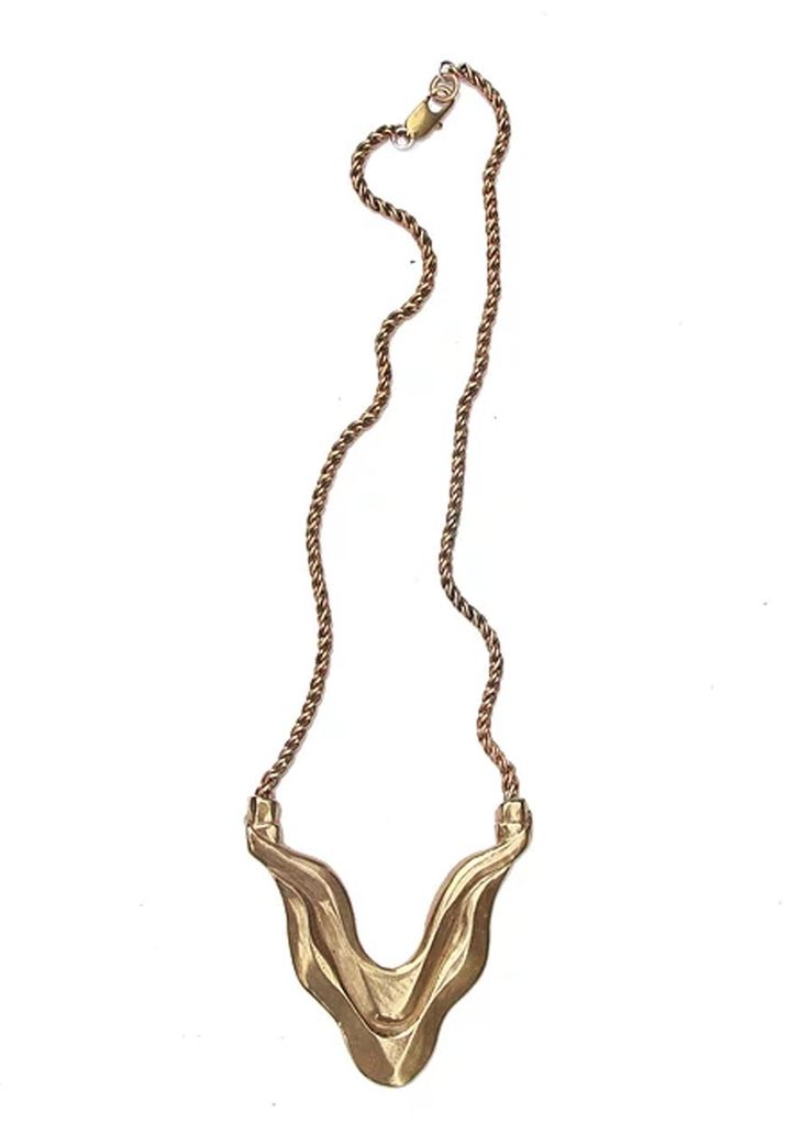 Hand carved brass pendant hangs on an 18" brass rope chain. Pendant is just under 3". Jewelry Care: WATERSANDSTONE jewelry is made primarily with brass. Brass will eventually build up an antique finish as it is worn. Many people like this natural patina, but if you are not happy with it, you can polish your jewelry with an over the counter brass cleaner and a soft cloth. Hand Cast Metal Amulet Necklaces, Antique Gold Medallion Necklace In Brass, Gold-tone Brass Pendant Chain Necklace, Gold Antique Finish Copper Necklaces, Gold Copper Necklace With Antique Finish, Antique Gold Copper Necklace, Bronze Medallion Necklace In Brass, Antique Electroformed Pendant Necklace, Hand Cast Copper Pendant Necklaces