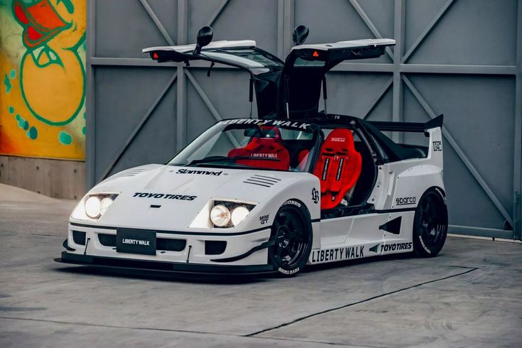 a white race car parked in front of a building