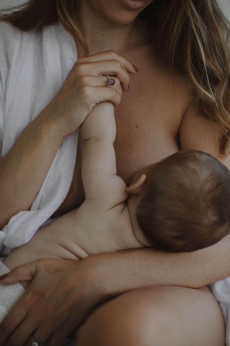 a woman holding a baby in her arms