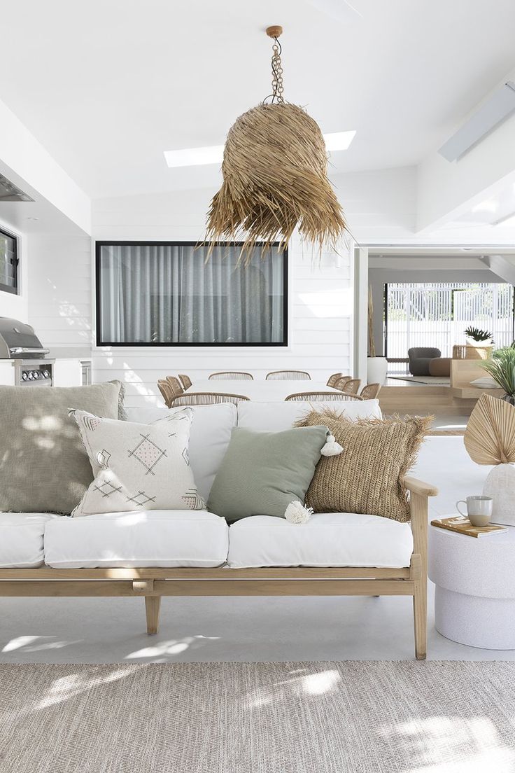 a living room with white couches and pillows on the sofa is featured in instagram