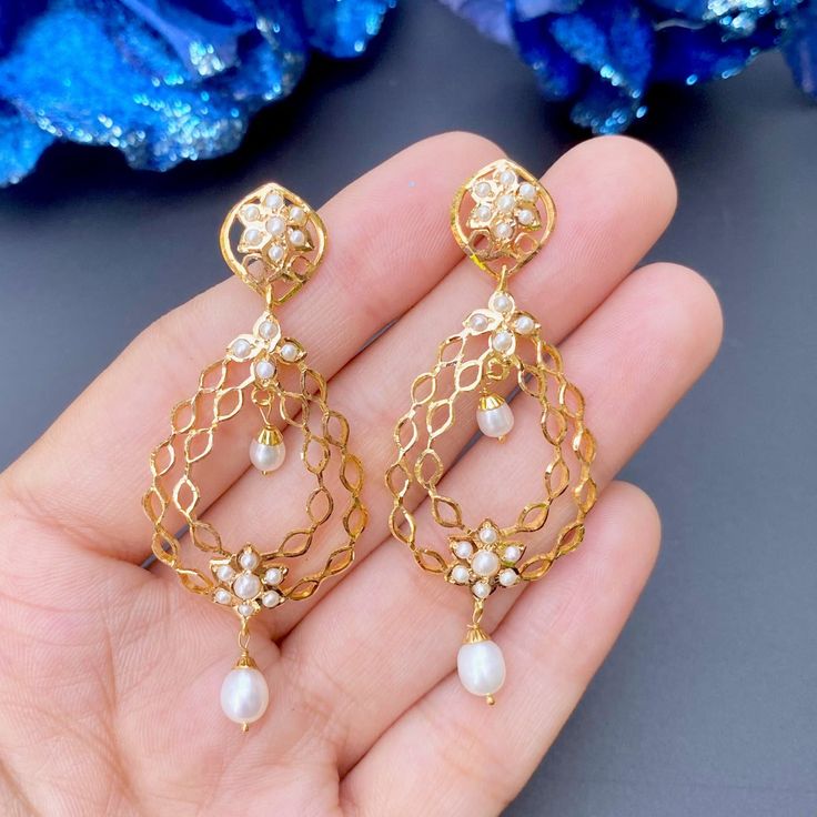 Featuring a pair of lightweight and elegant pearl drop earrings made in 22ct gold. The earrings weigh 10.38 GMs including 0.66 GMs of hanging pearl. Watch Video Here Wedding 22k Gold Danglers, 22k Gold Drop Earrings For Bridal Celebration, Gold Pearl Earrings 22k As Gift, Gold Chandelier Earrings With Pearl Drop, Elegant Round Danglers With Pearl Drop, 22k Gold Drop Chandelier Earrings For Wedding, Elegant 22k Gold Earrings With Latkans, Yellow Gold Drop Danglers For Wedding, Wedding Yellow Gold Drop Danglers