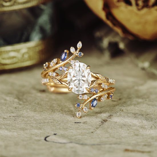 a close up of a ring with a diamond and blue sapphire stones on it's side