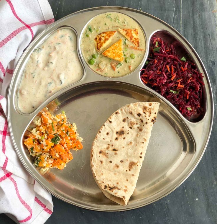 a metal plate topped with different types of food