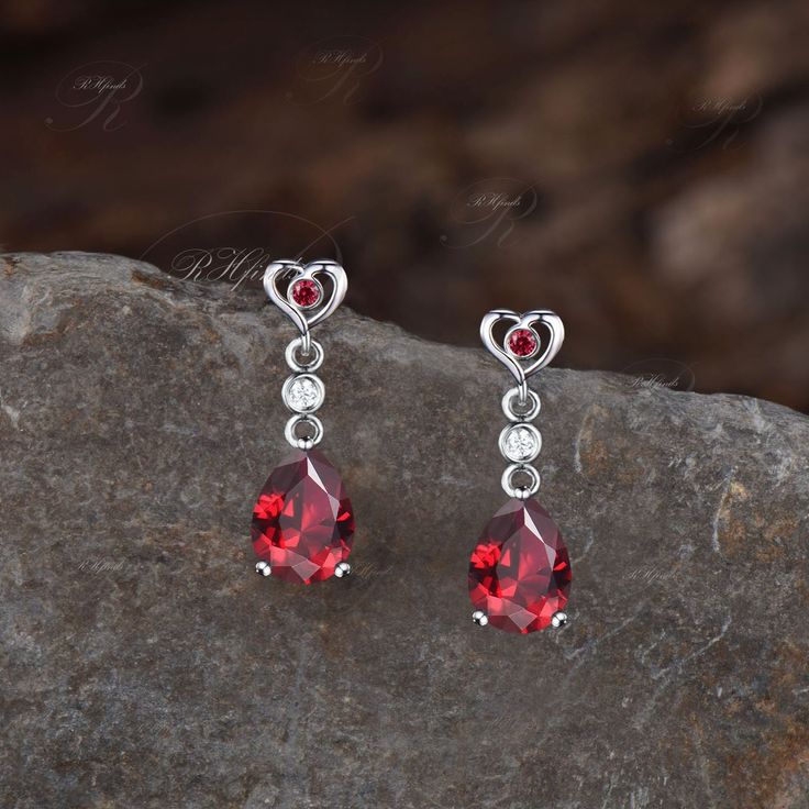 Product Detail Material: 925 Sterling Silver, 10k/14k/18k Solid Rose/White/Yellow Gold, Platinum Quantity: 2pcs (a pair) earrings Center Stone: 6x8mm Pear Cut Lab Ruby Side Stones: Round Cut Lab Ruby and Moissanites Custom Service 1, Gemstones can be replaced with others. 2, All metal can be customized. 3, The earrings can be customized according to the design you want. Please contact us if you need any personalized custom earrings. We will try our best to meet your needs. Only you can't think o Valentine's Day Gemstone Earrings Gift, Sterling Silver Earrings For Valentine's Day Formal, Cubic Zirconia Earrings For Anniversary, Fine Jewelry Dangle Earrings For Anniversary, Anniversary Drop Earrings With Gemstones, Gemstone Drop Earrings For Anniversary, Anniversary Gemstone Drop Earrings, Anniversary Dangle Heart Earrings For Pierced Ears, Elegant Earrings For Valentine's Day Anniversary Gift