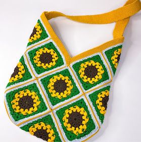 a crocheted green and yellow purse on a white surface