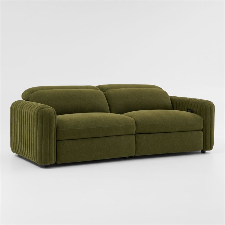 a green couch sitting on top of a white floor