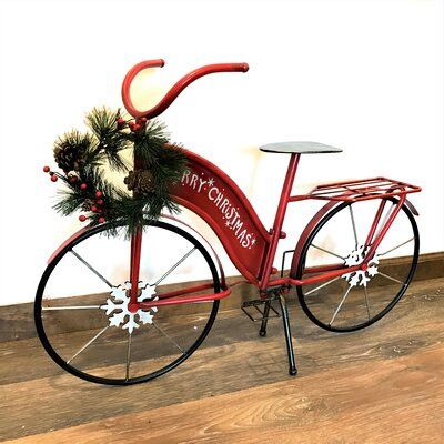 a red bicycle with a christmas decoration on the front