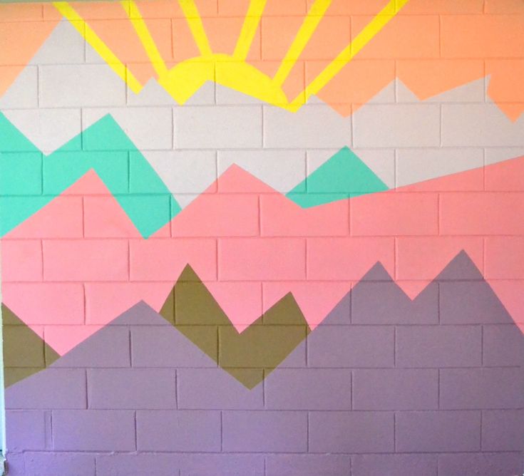 a wall painted with colorful mountains and sun