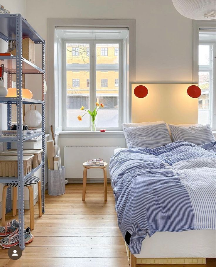 a bedroom with a bed and shelves in it