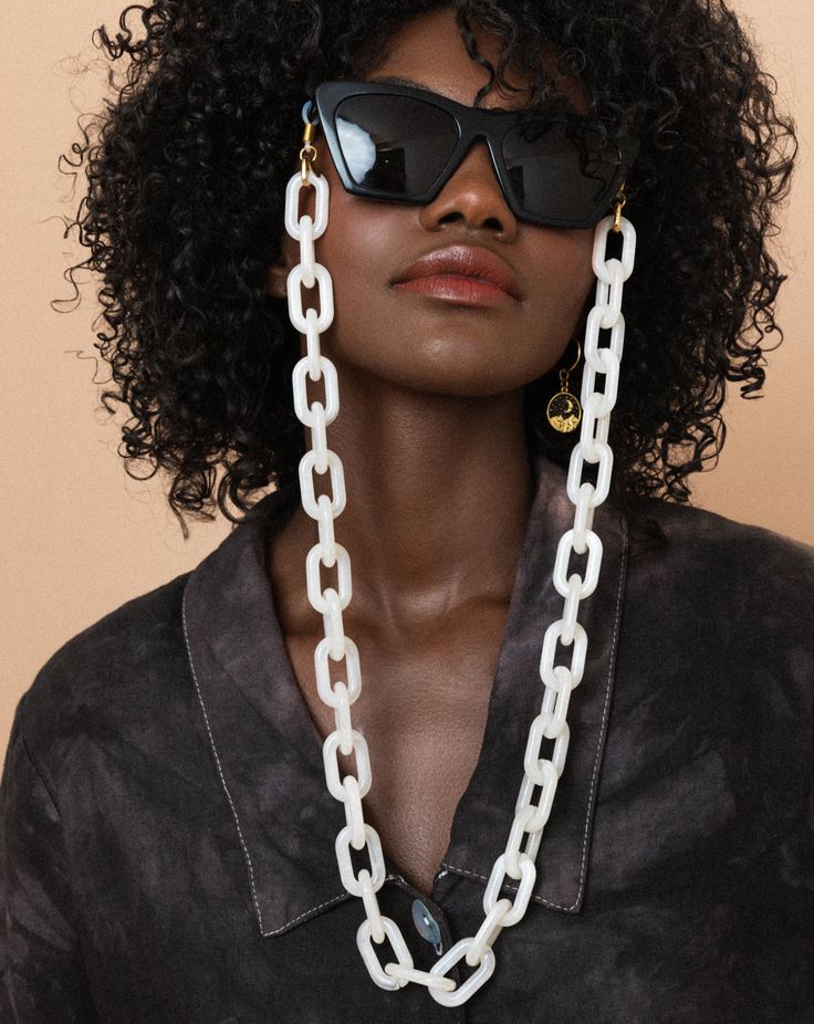 [because there is nothing boring about you]We know you're not one to wear the same thing and look like everyone else, and that goes for your eyewear too. With a look as sweet as frosting, these chains will keep your (sun)glasses close by while adding some fun and whimsy to your outfit. This extra chunky design is sure to turn heads - and it's just the accessory your glasses need to stay put.•Extra chunky acrylic oval chains•Gold + clear rubber loop end•Gold oval ring to prevent rubber loop from White Adjustable Glasses Chains For Fashion, White Adjustable Glasses Chains For Summer, Trendy White Glasses Chains, Trendy White Resin Jewelry, Trendy Summer Glasses Chains With Chain Strap, Chic White Chain Necklace For Everyday, White Glasses Chains For Summer, White Summer Glasses Chains, Summer White Glasses Chains