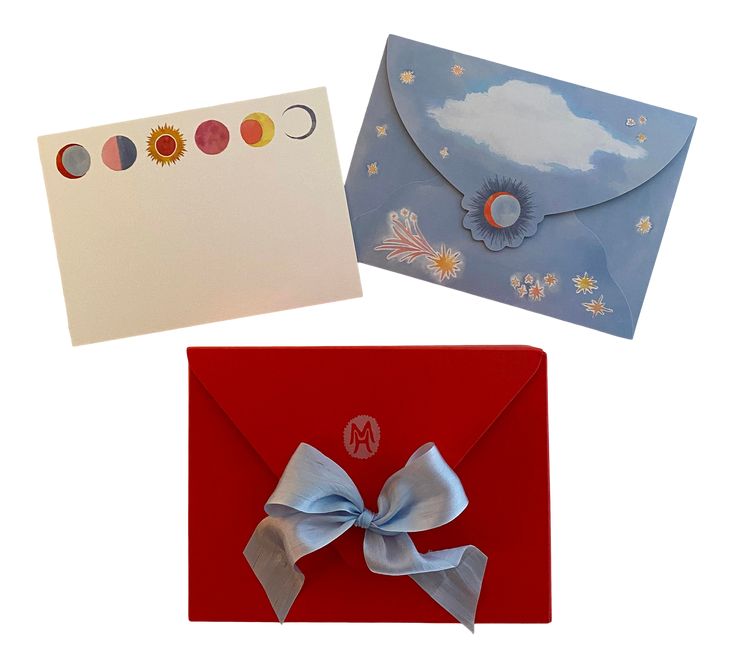 three greeting cards with bows on them, one in blue and the other in red