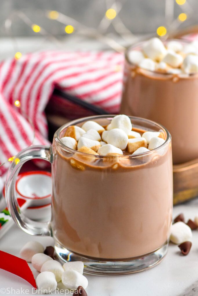 two mugs filled with hot chocolate and marshmallows