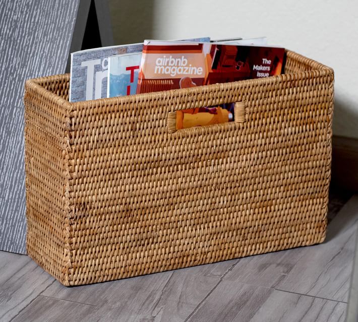 a wicker basket with magazines in it