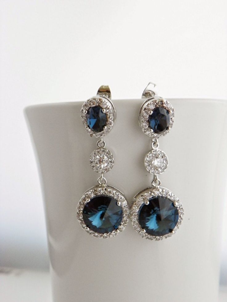 "Handmade Sterling Silver Earrings feature sparkly Montana Blue Swarovski crystals that are set in frames designed and made exclusively for Estylo Jewelry. These beautiful earrings are made of Crystallized Elements drops that hang from Sterling post earrings with matching blue Swarovski crystals surrounded by tiny clear Cubic Zirconia stones and round cubic zirconia connectors. They are perfect for a wedding or any other special occasion. They are gorgeous as focal point of your outfit. Also gre Blue Sterling Silver Chandelier Earrings For Wedding, Blue Cubic Zirconia Dangle Chandelier Earrings, Blue Cubic Zirconia Crystal Earrings For Wedding, Blue Cubic Zirconia Chandelier Earrings, Blue Round Chandelier Earrings For Wedding, Blue Crystal Bridal Earrings With Matching Set, Blue Crystal Bridal Earrings, Sparkling Blue Dangle Earrings, Sparkling Blue Crystal Earrings