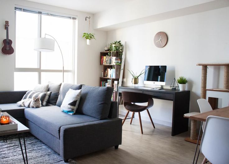 a living room filled with furniture and a flat screen tv sitting on top of a wooden table