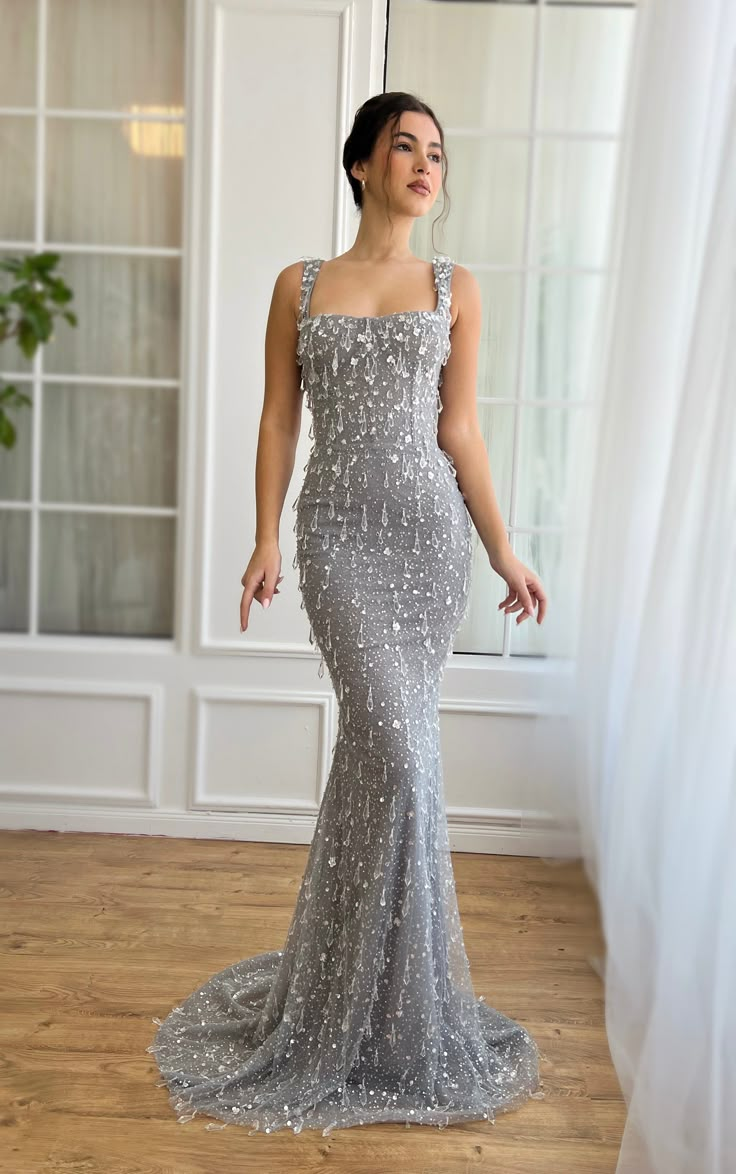 Discover elegance redefined with our exquisite sequined gown, designed to make every moment unforgettable. Crafted from high-shine, silver sequined fabric, this masterpiece is intricately adorned with crystal clear tear-drop embroidery, ensuring you sparkle from every angle. The dress features a flattering sweetheart neckline, complemented by a bodice with built-in pads and boning for a sculpted silhouette. Embrace the allure of the mermaid silhouette, meticulously fitted through the hips and th Dresses With Crystals, Exquisite Gowns, فستان سهرة, Glam Dresses, Silver Dress, Mermaid Dress, Mermaid Prom Dresses, Celebrity Dresses, Classy Dress