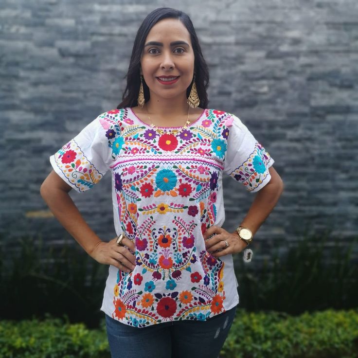 This feminine vintage style shirt is beautifully made. Black with colorful flowers, it is a unique one of a kind. It is shown with a belt as an example of how you might want to wear it. Since it is hand embroidered, each flower is slightly different. It is made of cotton and it extremely comfortable. About Our Items: Each one of our items are handmade/hand woven by Indigenous communities of Chiapas and Oaxaca in Mexico. Great care has been taken to ensure the quality of uniqueness of each item w Traditional Short Sleeve Printed Blouse, Traditional Printed Shirt For Festivals, Traditional Multicolor Printed Shirt, Traditional Printed Tops For Festivals, Traditional Crew Neck Top For Festivals, Fitted Summer Tops With Motifs, Bohemian Short Sleeve Top With Multicolor Embroidery, Traditional Multicolor Tops With Motifs, Bohemian Shirt With Multicolor Embroidery