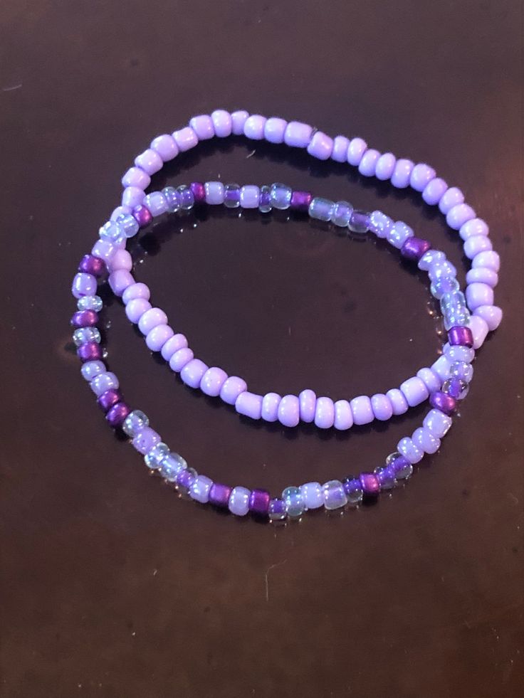 These handmade purple bracelets are just full of bright color!  Either one is sure to please any purple lover like myself!  Whether you decide on the light purple, shades of purple, or stack them both, I'm sure they will look gorgeous on you!  Very nice, bright colors. They compliment each other well.  Simple, but still adds color to any outfit! Adults and kids sizes available! Handmade Purple Stretch Bracelet For Beach, Handmade Adjustable Purple Bracelets, Handmade Adjustable Purple Bracelet, Purple Round Beads Bracelet For Beach, Adjustable Purple Stretch Bracelet For Friendship, Adjustable Lavender Bracelets For Beach, Trendy Purple Friendship Bracelets As Gift, Bohemian Purple Stretch Bracelet With Round Beads, Adjustable Lavender Stretch Bracelet