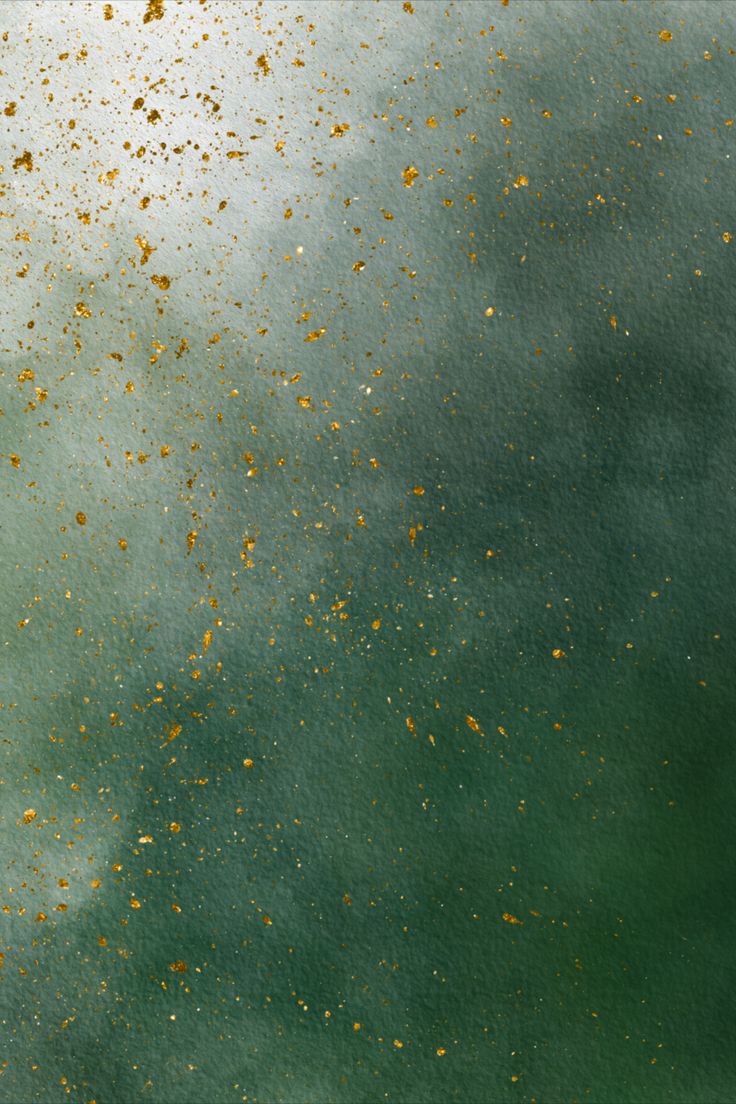 an abstract painting with gold flecks on green and blue watercolor paper background