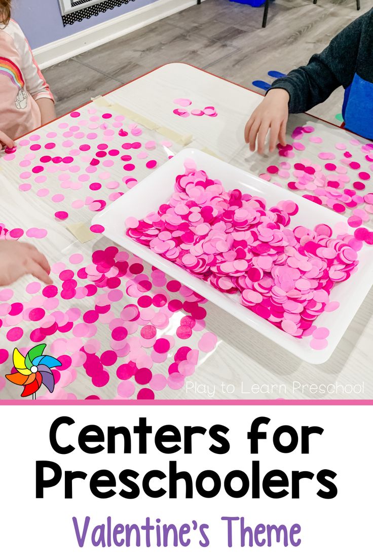 two children at a table making valentine's day crafts with the words centers for preschoolers