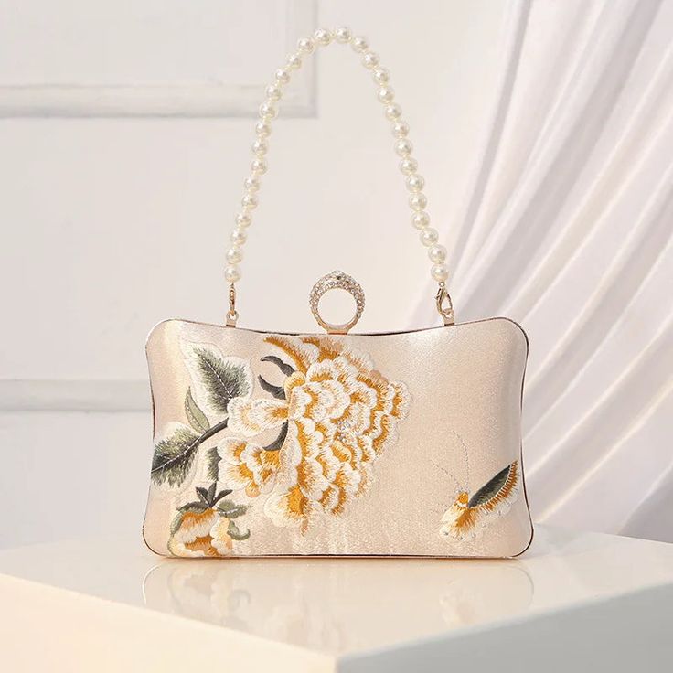 44587084513332 Elegant Rectangular Evening Bag For Ceremony, Beige Embroidered Evening Bag For Events, Elegant Embroidered Handheld Evening Bag, Feminine Rectangular Evening Clutch, Elegant Cream Bag For Ceremonies, Floral Embroidery Evening Clutch For Events, Elegant Cream Embroidered Evening Bag, Feminine Rectangular Evening Bag, Feminine Clutch Evening Bag For Events