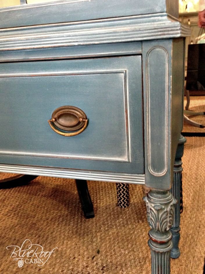 an old dresser is painted blue and gold