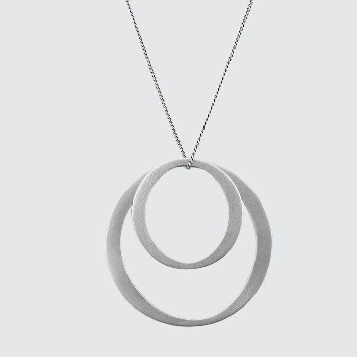 Satin sterling silver organic circles looped over an antiqued silver curb chain. Stylish, contemporary, graphic. -approx. 1 3/4" diameter on large organic circle-18" sterling silver thin curb chain -spring ring closure-PJ778 Engagement Games, Double Circle Necklace, Chicago Gifts, Miscellaneous Gifts, Contemporary Graphic, Blue Q, Grad Gifts, Branded Gifts, Circle Necklace