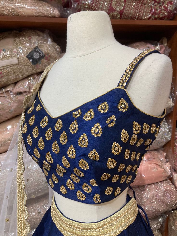 Navy blue plain lehenga with gold border teamed with beautiful cut dana and stone work blouse and contrasting ivory net dupatta. Fabric: Silk Occasion: Wedding Ceremony or Reception. WASH CARE INSTRUCTIONS - Please Dry clean only when it is applicable. Slight color variation is possible due to digital photography. This outfit can be customized in multiple colors and specific to client measurements. 120 days of production time is required and are for bulk orders only!Order are processed in store Semi-stitched Royal Blue Blouse Piece For Wedding, Party Choli With Resham Embroidery In Royal Blue, Blue Party Blouse Piece With Dori Work, Party Blouse Piece With Blue Dori Work, Blue Blouse Piece With Dori Work For Party, Gold Cutdana Traditional Party Wear, Blue Party Wear Blouse Piece With Zari Work, Blue Zari Work Blouse Piece For Party Wear, Blue Party Wear Dupatta With Traditional Drape