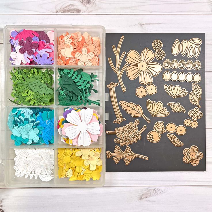 an assortment of paper flowers in a plastic container