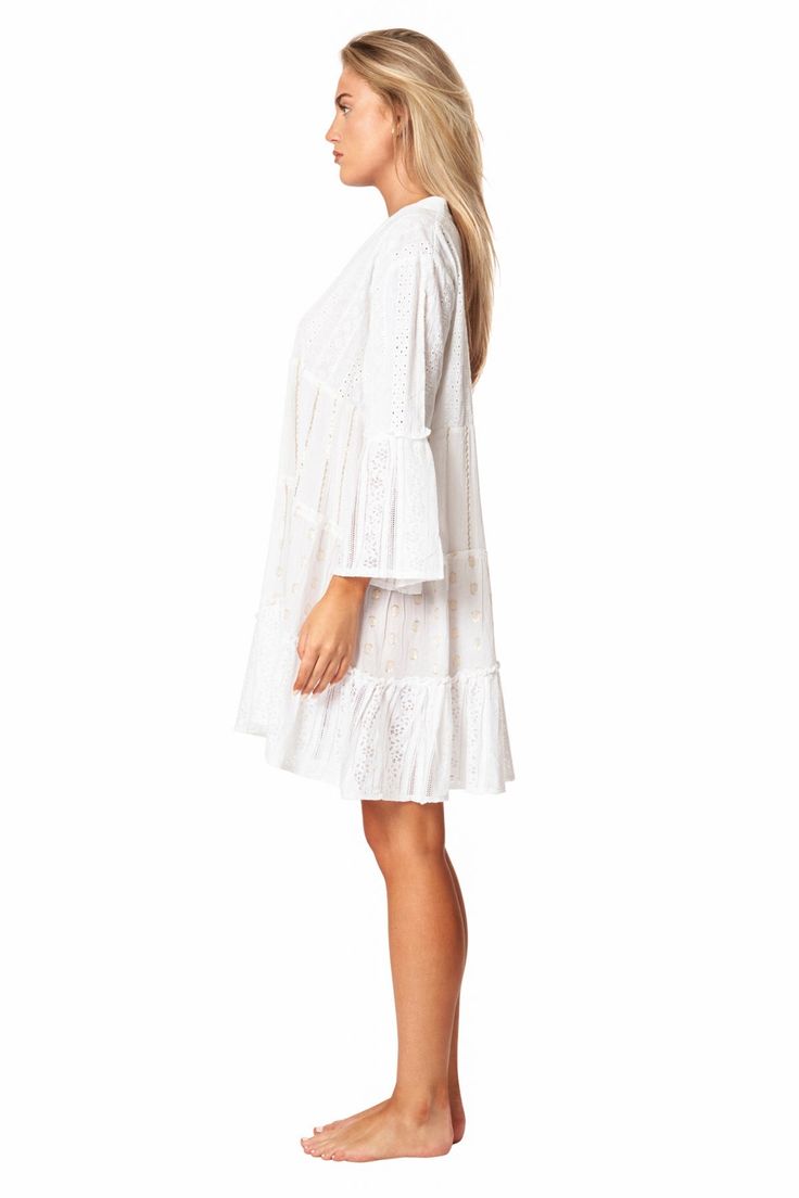 Camella Casual Mini Dress by La Moda. Just as effortless as it is essential, this stunning mini dress is featured in a tiered relaxed body with exaggerated sleeves. The perfect throw-on-and-go mini to pair with a staple sandal in the warmer months or a bold boot in the colder, this cool and classic dress is sure to be your go-to from season to season. 100% Cotton This is a unique garment. The imperfections in these fabrics are not considered defects, but characteristics that make them authentic. Elegant Mini Dress With Ruffle Sleeves For Beach, Summer Daywear Dresses With Bell Sleeves, Elegant Ruffle Sleeve Mini Dress For Vacation, Feminine Ruffle Sleeve Mini Dress For The Beach, Summer Bell Sleeve Dresses For Daywear, Elegant Mini Dress With Ruffle Sleeves For Vacation, Flowy Mini Dress With Bell Sleeves And Ruffle Hem, Long Sleeve Tiered Dress With Ruffle Hem For Summer, Summer Long Sleeve Tiered Dress With Ruffle Hem