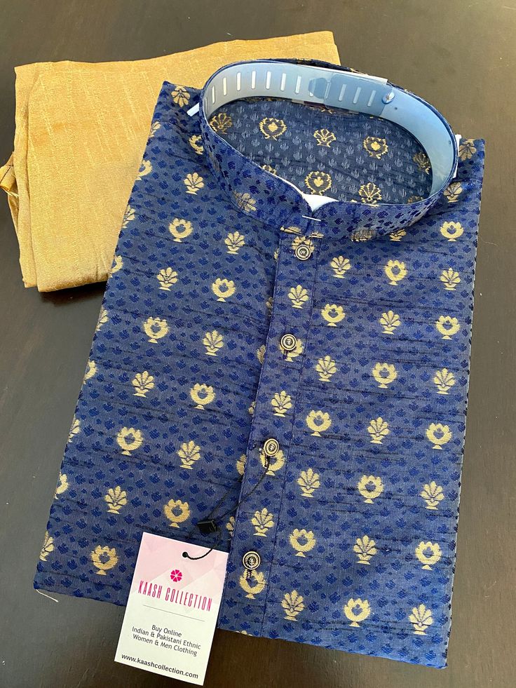 "Premium quality Cotton Silk Kurta Pajama Set. Super Soft material. Fancy Buttons and Printed design pattern all over the Kurta. Item : Men's Kurta Pajama Set Ready to Wear : Yes Kurta Color : Blue Pajama Color : Gold Pocket : Yes Fabric : Cotton Silk Work : Fancy buttons, Lining (Yes/No) : No Disclaimer -For sizing please refer to the Size Chart given in the listing with the pictures. - Please do NOT go by the size of the Kurta that you already have from another maker. All makers have different Indigo Kurta With Zari Work For Diwali, Bollywood Style Festive Sherwani With Printed Motifs, Bollywood Style Festive Indigo Kurta, Festive Bollywood Style Indigo Kurta, Festive Bollywood Sherwani With Printed Motifs, Designer Indigo Cotton Kurta, Designer Cotton Kurta In Indigo, Designer Indigo Sets For Festivals, Eid Festive Indigo Kurta