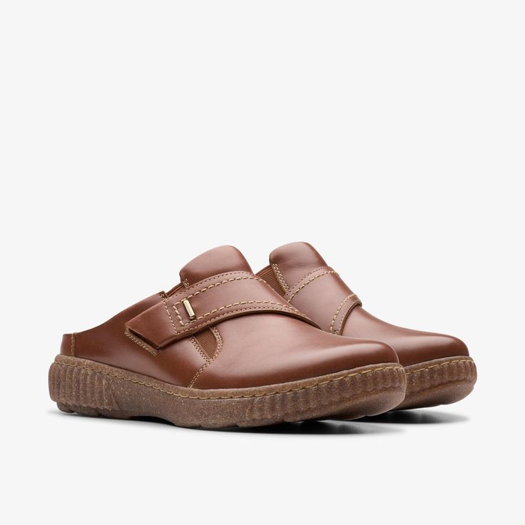 Womens Caroline Bay Tan Leather Mules | Clarks US Outdoor Slip-ons With Cushioned Footbed And Round Toe, Functional Synthetic Slip-ons With Round Toe, Sporty Brown Slip-ons With Rubber Sole, Brown Cushioned Slip-on Sneakers, Leather Footbed Slip-on Walking Shoes, Comfortable Ergonomic Slip-ons With Rubber Sole, Casual Slip-on Clogs With Textured Sole, Leather Slip-on Walking Shoes, Casual Slip-on Sneakers With Removable Insole For Walking