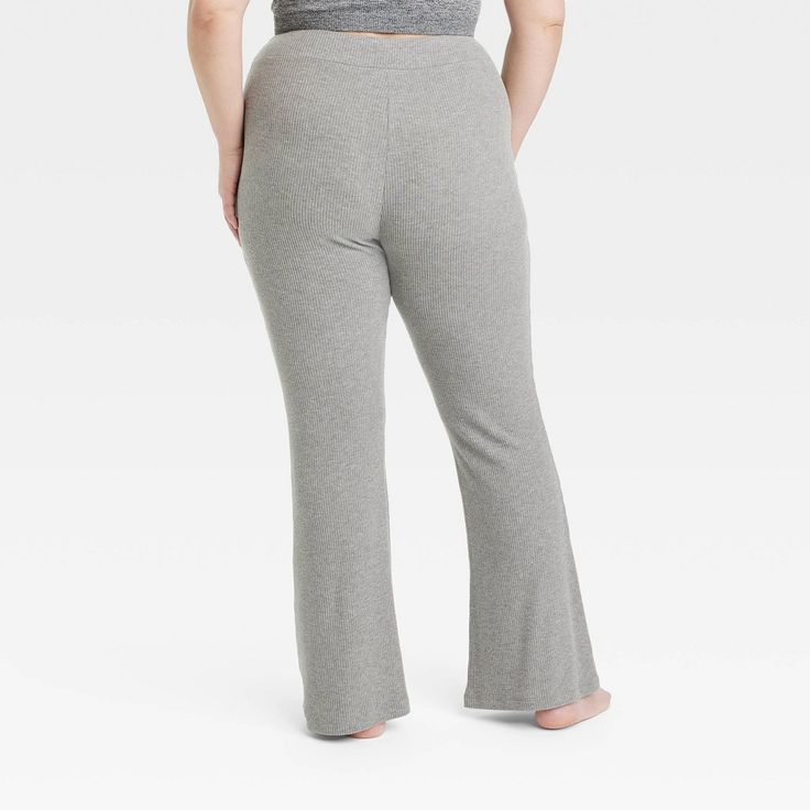 Update your sleepwear bottoms with these Cozy Ribbed Crossover Waistband Flared Legging Pajama Pants from Colsie™. These high-rise pajama leggings feature a cozy ribbed-textured finish and a flared cut with a casual fit. The crossover elastic waist offers a secure and easy pull-on fit, while the soft, stretchy material lends comfortable wear. Pair these pants with a comfy top and slippers for a complete look. Colsie™: All You, Inside and Out. Wide Leg Relaxed Fit Leggings For Loungewear, Relaxed Fit Wide Leg Leggings For Loungewear, Casual Solid Bottoms For Pajama Party, Non-stretch Full Length Bottoms For Loungewear, Comfortable Solid Bottoms For Pajama Party, Comfortable Solid Color Bottoms For Pajama Party, Full Length Yoga Pants With Ribbed Waistband For Loungewear, Solid Stretch Pants For Lounging, Comfortable Full-length Yoga Pants For Loungewear