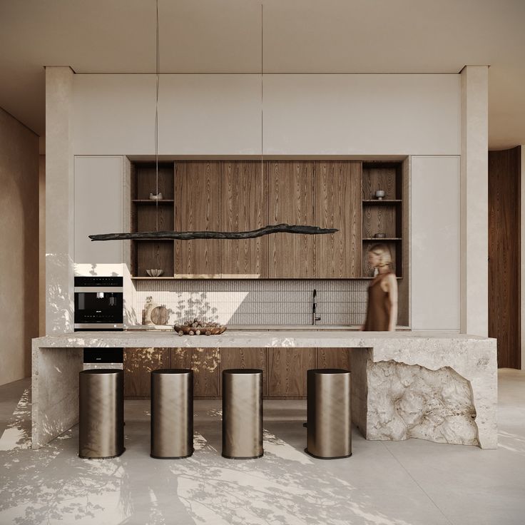 a modern kitchen with marble counter tops and stainless steel stools