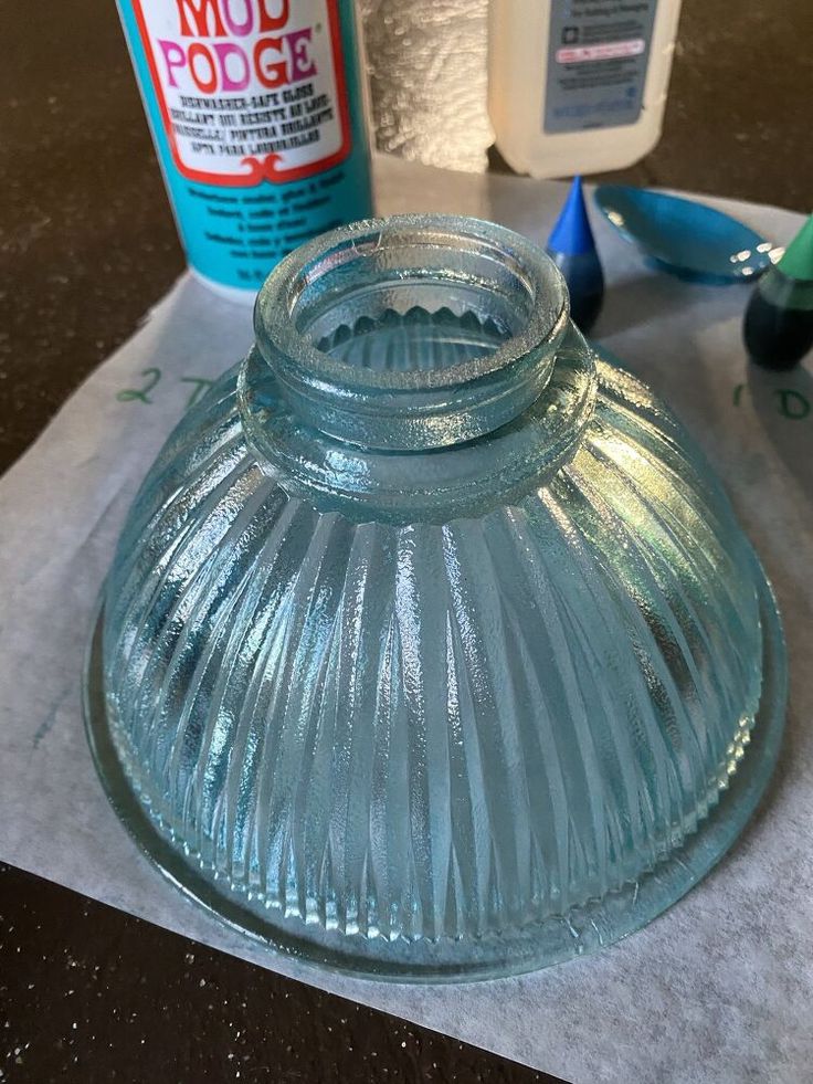 a glass jar sitting on top of a piece of paper