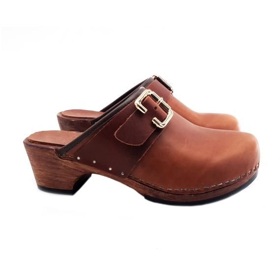 HANDMADE CLOGSwood-effect clogs made in italy-Brown leather upper with buckle-anti-slip sole-heel 5 cm-Designed and Manufactured by "MY CLOGS"DON'T FORGET TO CHECK THE SIZE BEFORE YOU COMPLETE THE ORDER!Size and LENGTH OF THE SHOE ALONG THE CURVE:35 EU  =  22.00 CM36 EU  =  22.50 CM37 EU  =  23.00 CM38 EU  =  23.50 CM39 EU  =  24.00 CM40 EU  =  24.50 CM41  EU  =  25.00 CM Leather Slip-on Mules With Tang Buckle, Leather Slip-on Clogs With Buckle Closure, Leather Mules With Tang Buckle And Round Toe, Leather Closed Toe Clogs With Rubber Sole, Brown Leather Mules With Buckle Closure, Brown Closed Toe Clogs With Removable Insole, Brown Closed Toe Clogs With Rubber Sole, Brown Open Heel Clogs With Rubber Sole, Brown Open Heel Mules With Leather Footbed