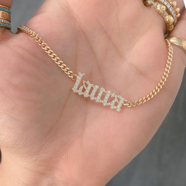 This unique personalized Old English font nameplate cut-out necklace is composed of 14K solid gold and beautifully pavé set with genuine GVs1 quality natural real Diamonds. This pendant is complemented by a durable 14K solid gold adjustable chain or can be purchased as a charm alone without the chain under the "Length" drop-down menu. NOTE: The item will be made in the exact casing of the characters entered. Please be mindful of this detail when providing the customization desired. Name Dimensio Luxury Custom Nameplate Jewelry, Luxury Classic Nameplate Necklace, Luxury Nameplate Jewelry, Custom Name White Gold Nameplate Jewelry, Luxury Custom Name Gold Jewelry, Luxury Gold Name Necklace With Custom Name, White Diamond Nameplate Jewelry, White 14k Gold Nameplate Jewelry, Custom Name Diamond Nameplate Jewelry