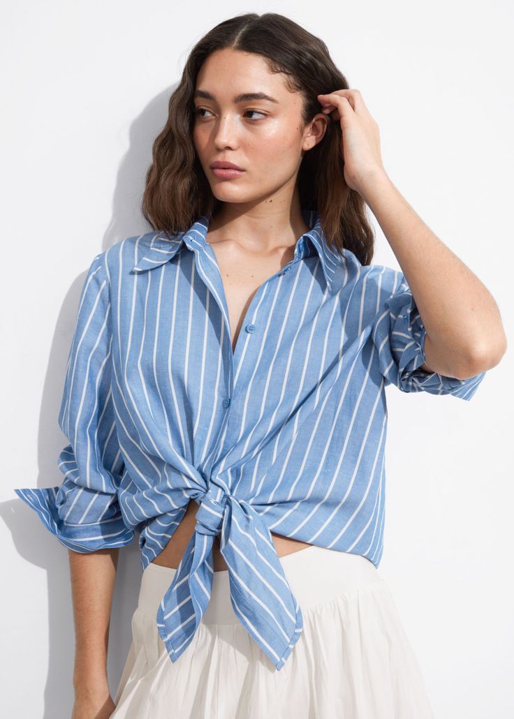 Long-sleeve shirt finished with tonal ties at the hem that knot into a neat bow.• Cropped silhouette• Full-spread collar• Five button closures• Buttoned cuffs• Length of shirt:53.5cm / 21.1" (EU 36 / UK 8 / US 4) Chic Shirt With Tie Sleeves For Spring, Casual Long Sleeve Shirt With Tie Sleeves, Spring Button-up Tops With Tie Waist, Chic Button-up Top With Tie Sleeves, Chic Tie Sleeves Button-up Tops, Tie Sleeve Button-up Tops, Casual Button-up Tie Waist Tops, Casual Button-up Tops With Tie Waist, Casual Cotton Shirt With Tie Sleeves