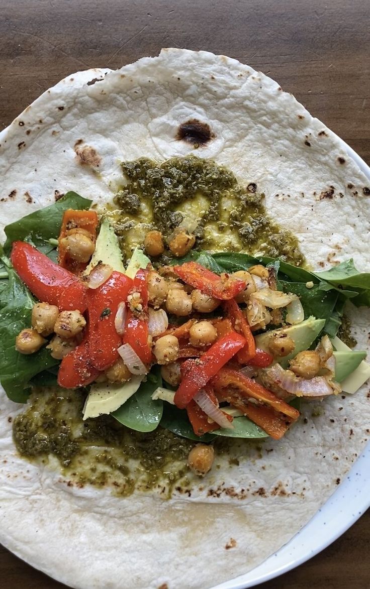 a tortilla with spinach, tomatoes and chickpeas