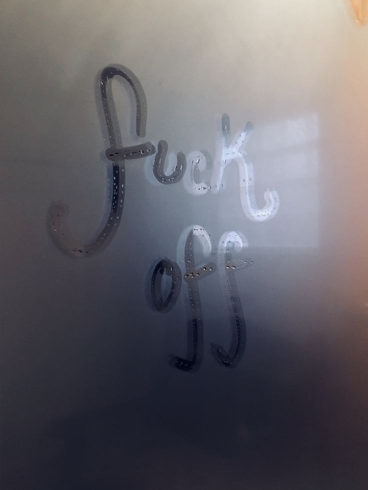 a frosted glass door with the words look off written in cursive writing