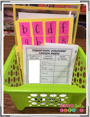 a green basket with pink and yellow cards in it that spell out the word,