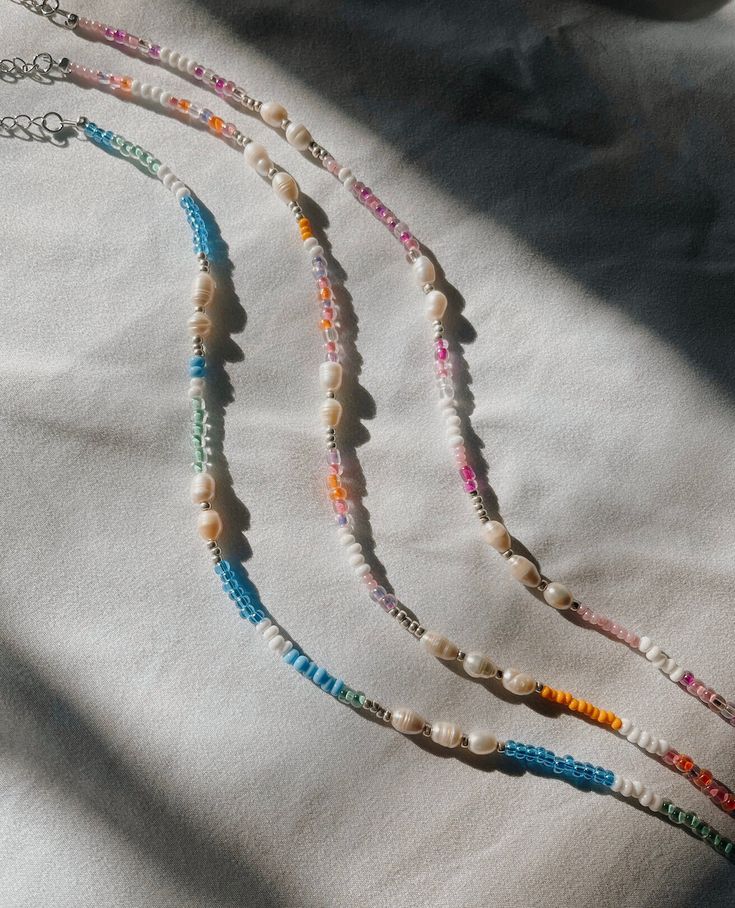 These coastal collection necklaces come in pink, multi sunset, and blue :) Perfect for summer and the beach! 20% of profits made will be donated to local women's health organizations. Coastal Grandma Jewelry, Cute Beachy Jewelry, Beaded Beach Jewelry, Colorful Letter Beads Necklace For Summer, Colorful Summer Necklaces With Letter Beads, Colorful Summer Letter Beads Necklace, Pink Strand Necklaces For Summer, Handmade Colorful Necklaces For Vacation, Pink Beach Necklace For Summer